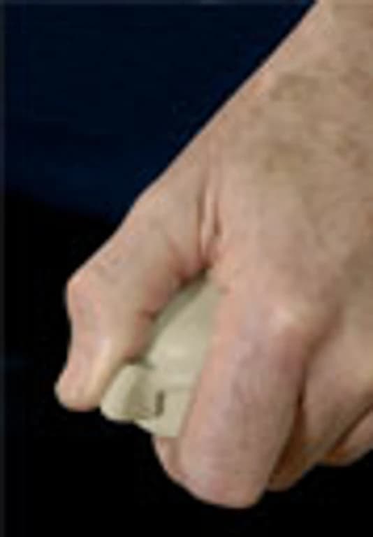 Hand using the paddle control on a Brooks stairlift arm